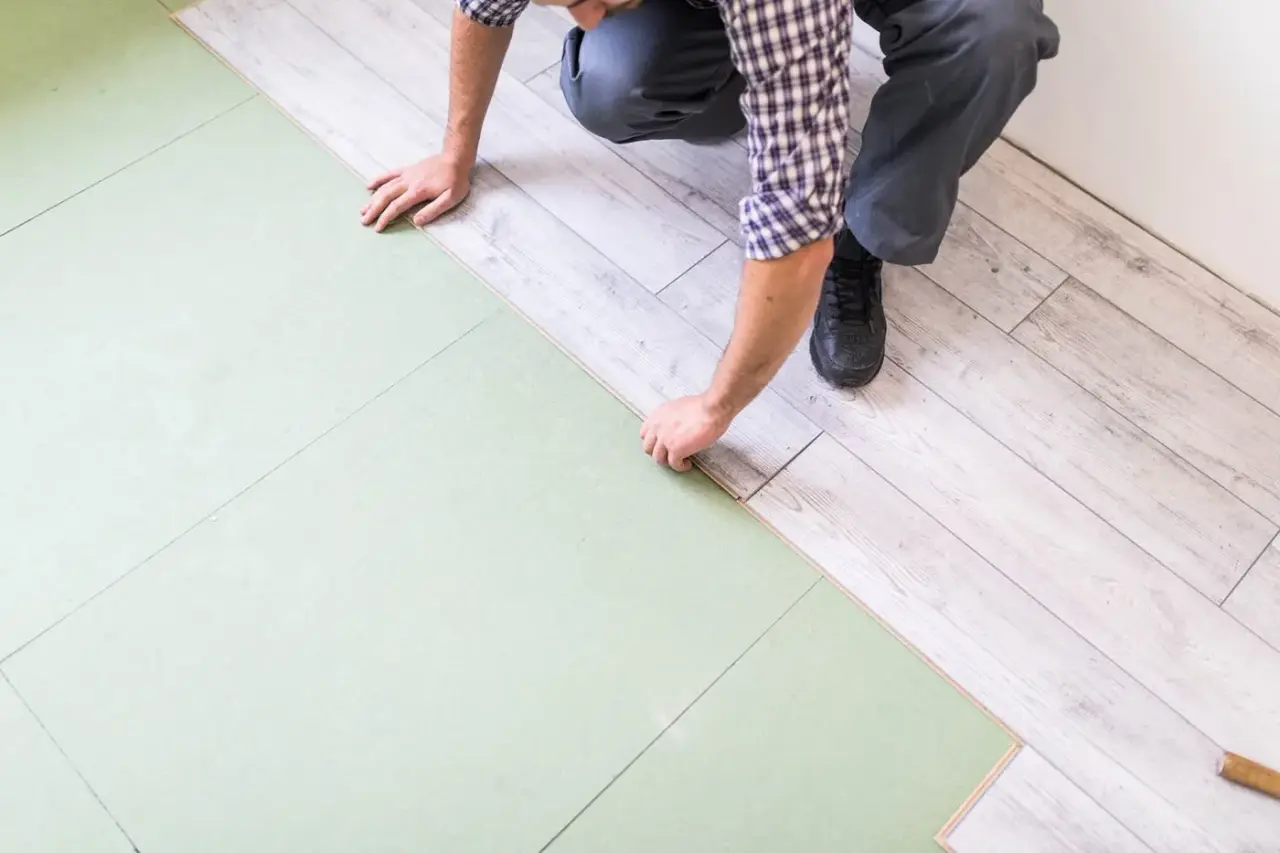 Técnico instalando un piso laminado